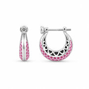 Silver hoop earrings with pink enamel heart pattern on a white background