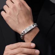 Silver bracelet on a person's wrist with a dark background